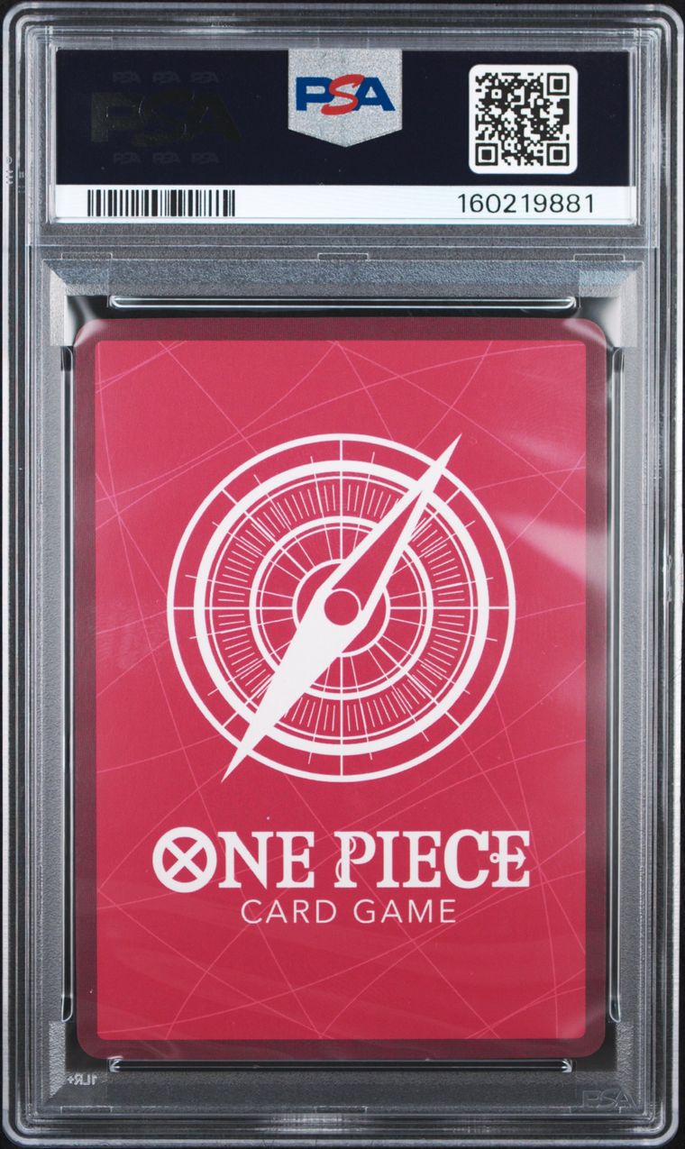 A PSA graded One Piece Card Game card pack in a clear plastic slab. The pack has a red background with a white compass graphic and the text 'ONE PIECE CARD GAME' at the bottom.