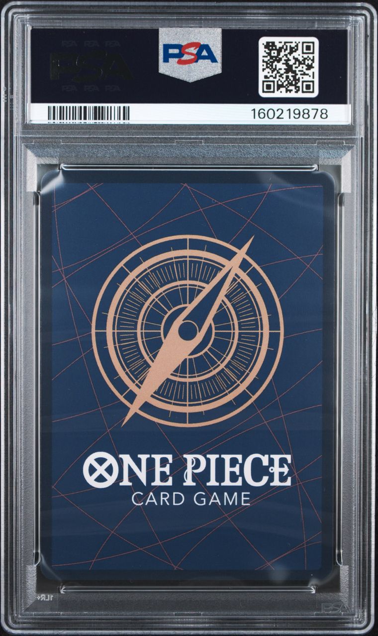 PSA graded One Piece Card Game deck box in a clear plastic PSA holder, featuring a dark blue box with a gold compass design and white One Piece branding.