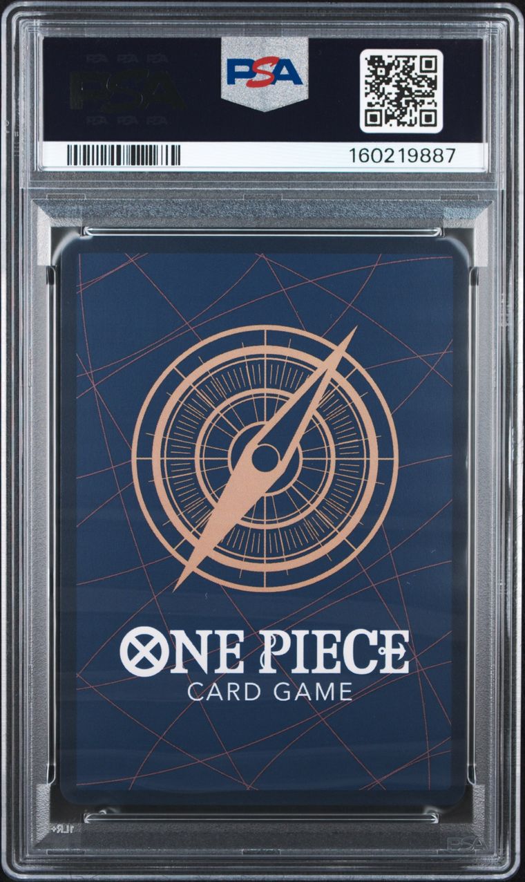 PSA graded One Piece Card Game deck box in a clear plastic PSA holder, featuring a dark blue background with a compass design and white text.