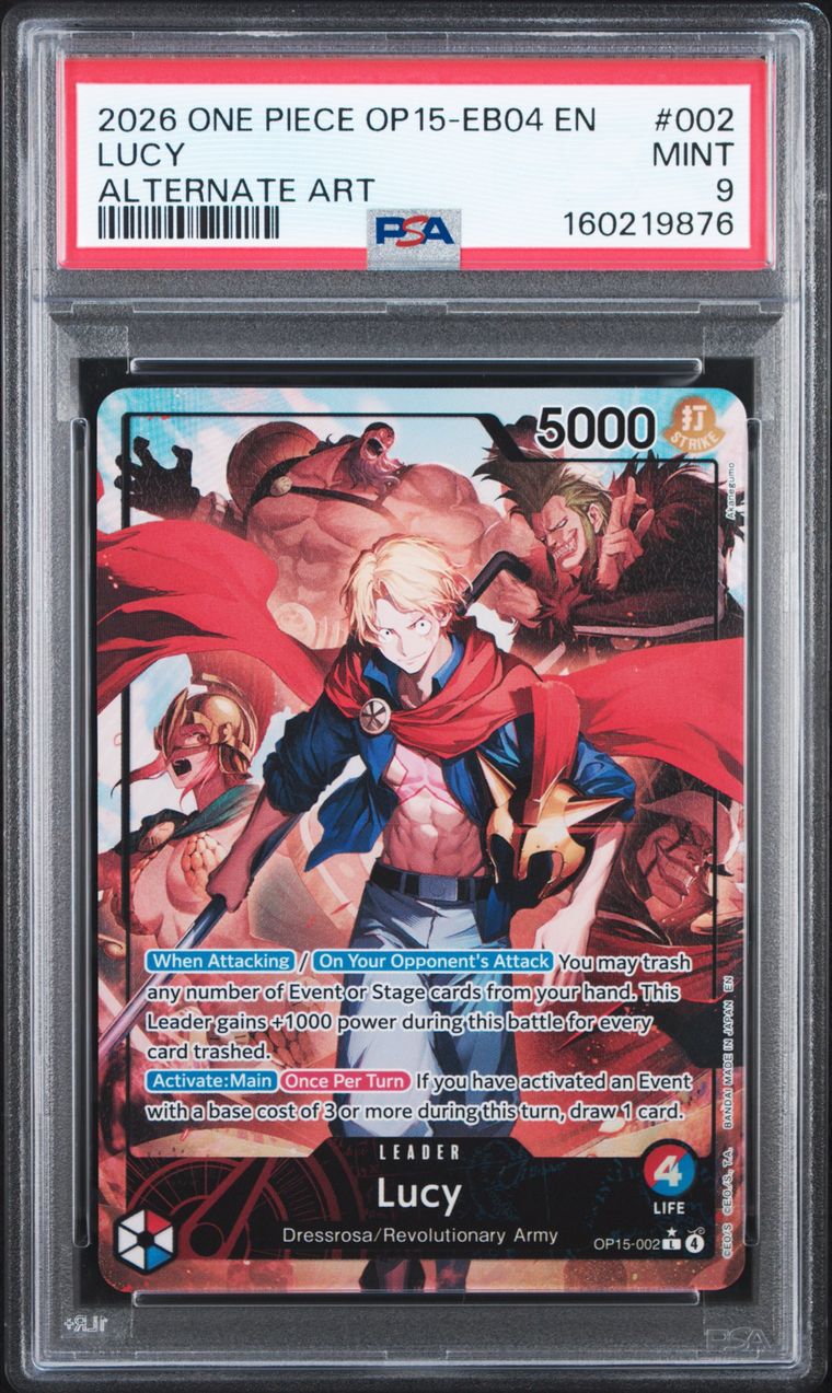 A graded One Piece trading card featuring the character Lucy, sealed inside a clear PSA grading case. The card is labeled '2026 ONE PIECE OP15-EB04 EN' with a red PSA header and a black card body showing anime artwork with red, blue, and flesh tones.