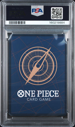 A PSA graded One Piece Card Game deck box inside a clear plastic grading case, showing a dark blue box with a gold compass design and white One Piece branding.