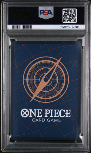 A PSA graded One Piece Card Game deck box inside a clear plastic grading case, featuring a dark blue background with a copper compass design and white One Piece branding.