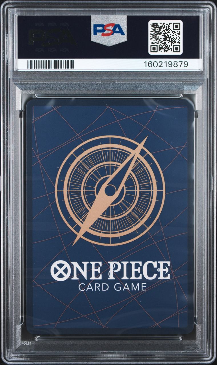 PSA graded One Piece Card Game card deck box inside a clear PSA encapsulation, featuring a dark blue background with a gold compass design and white One Piece branding.